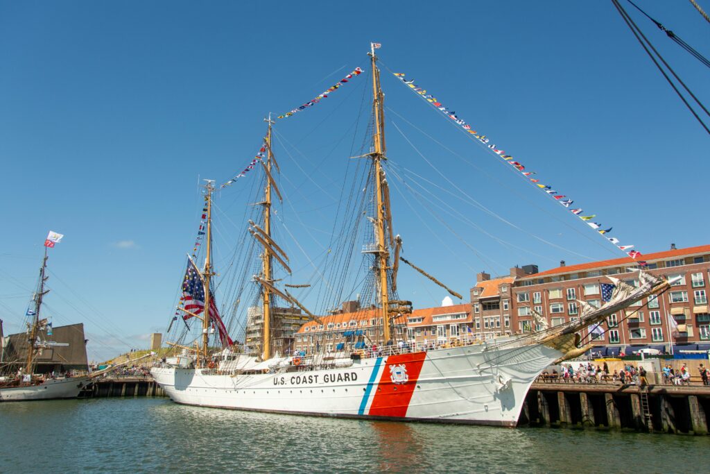 U.S. Coast Guard tall ship docked in Den Haag, showcasing maritime culture.